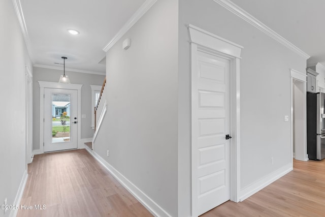 457 Raven Glen Dr, Southport, NC 28461 - hallway featuring ornamental molding, light wood-type flooring, stairs, baseboards, and recessed lighting