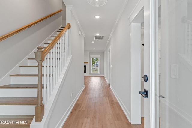 457 Raven Glen Dr, Southport, NC 28461 - entryway featuring light wood-style flooring, ornamental molding, stairway, recessed lighting, and baseboards
