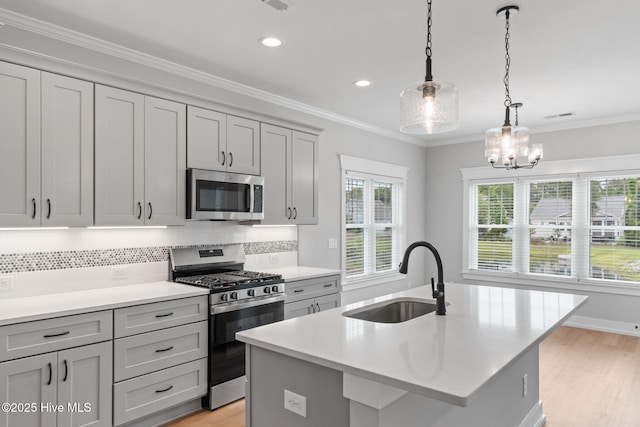 457 Raven Glen Dr, Southport, NC 28461 - kitchen featuring stainless steel appliances, a sink, gray cabinets, light countertops, and backsplash