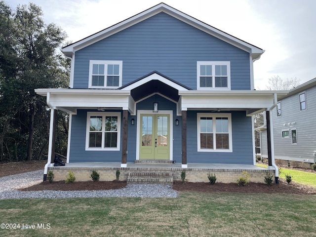 view of front of property with a porch and a front lawn