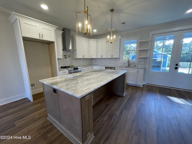 kitchen with white cabinets, dark hardwood / wood-style flooring, and wall chimney range hood