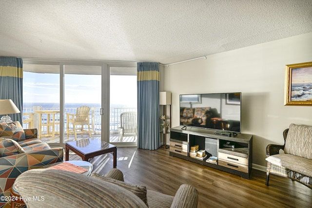 living room featuring floor to ceiling windows, dark hardwood / wood-style flooring, and a textured ceiling