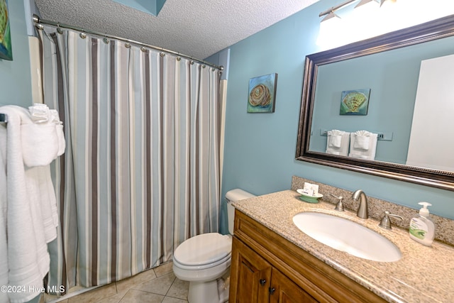 bathroom with vanity, a shower with curtain, tile patterned flooring, toilet, and a textured ceiling