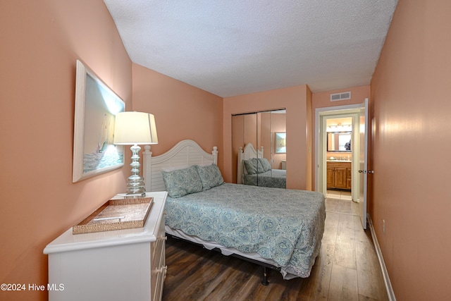 bedroom featuring a closet, hardwood / wood-style floors, and a textured ceiling