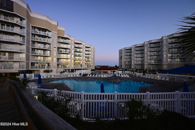 view of pool at dusk