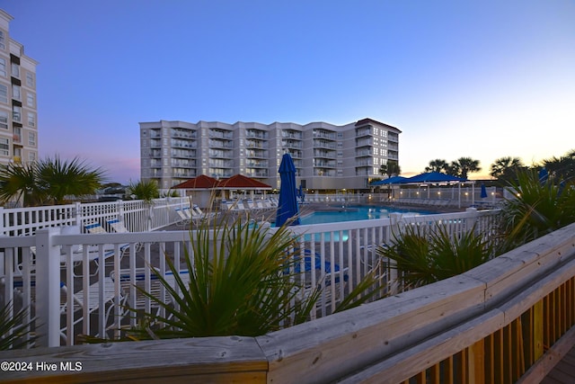 view of pool at dusk