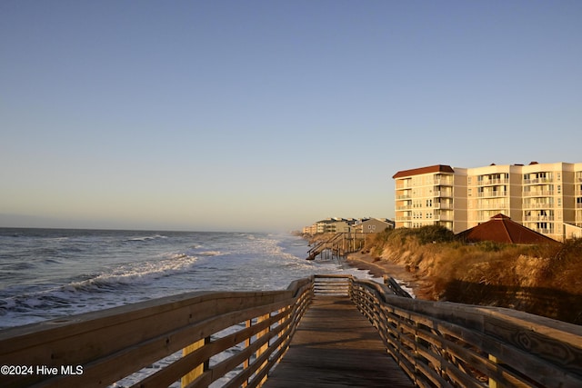 surrounding community featuring a water view and a view of the beach