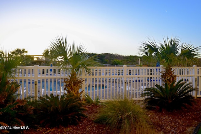 view of pool at dusk