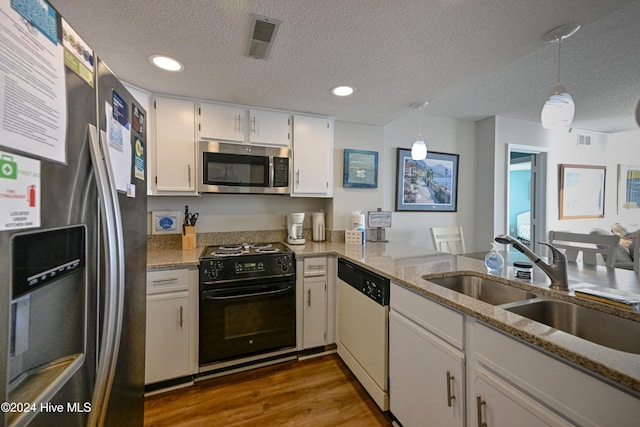 kitchen with white cabinets, pendant lighting, a textured ceiling, and appliances with stainless steel finishes