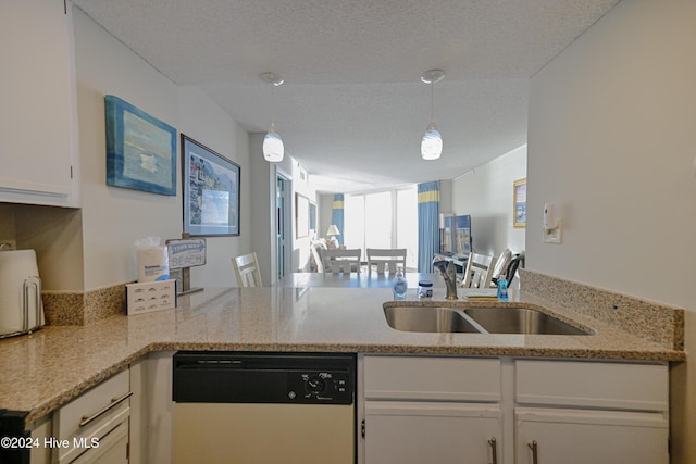 kitchen featuring dishwasher, sink, hanging light fixtures, a textured ceiling, and white cabinetry