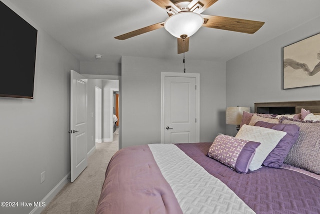 bedroom featuring ceiling fan and light carpet