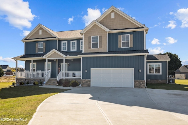 craftsman-style home with a front lawn, covered porch, and a garage