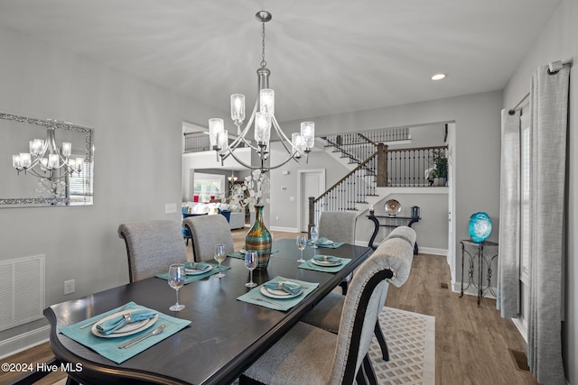 dining area featuring a notable chandelier and hardwood / wood-style flooring