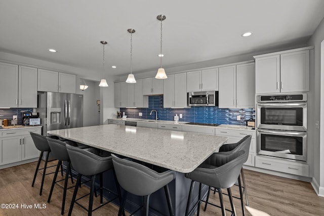 kitchen with a center island, stainless steel appliances, and dark hardwood / wood-style floors