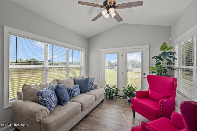 living room with light hardwood / wood-style floors, ceiling fan, and lofted ceiling