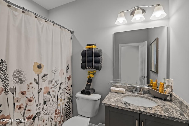 bathroom featuring vanity, toilet, and walk in shower