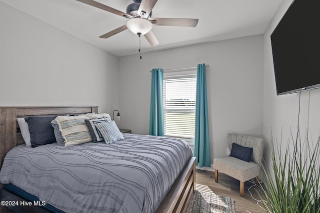 bedroom with hardwood / wood-style floors and ceiling fan