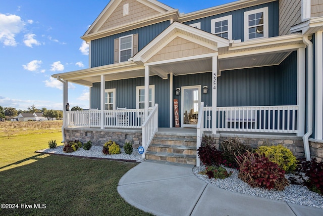 view of front of house featuring a front yard and a porch