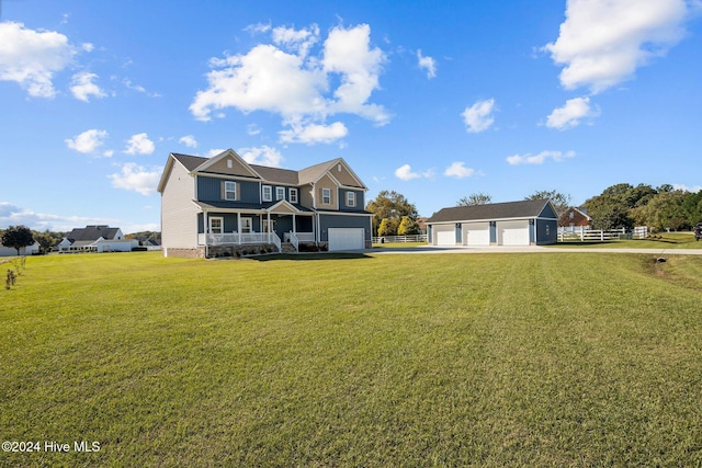 view of front of home with a garage, an outdoor structure, and a front yard