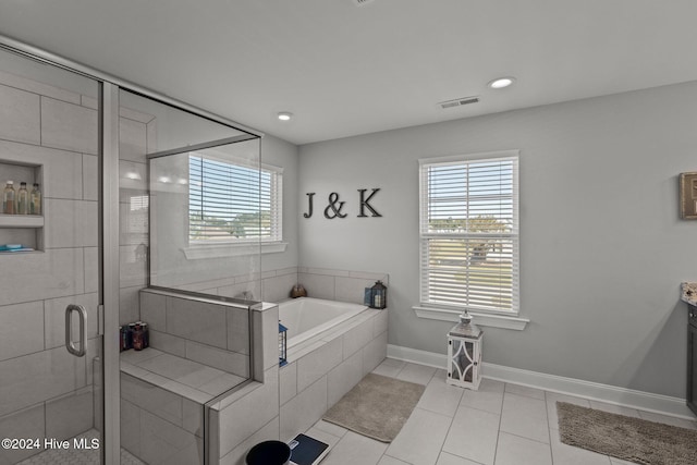 bathroom with tile patterned flooring, vanity, and separate shower and tub