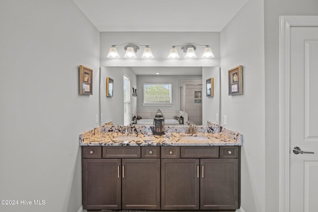 bathroom featuring vanity and independent shower and bath