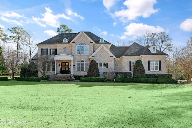 french country inspired facade with french doors and a front yard