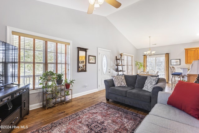 living room with dark hardwood / wood-style flooring, high vaulted ceiling, and ceiling fan with notable chandelier