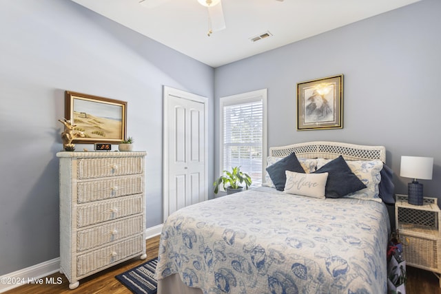 bedroom featuring ceiling fan, a closet, and dark hardwood / wood-style floors