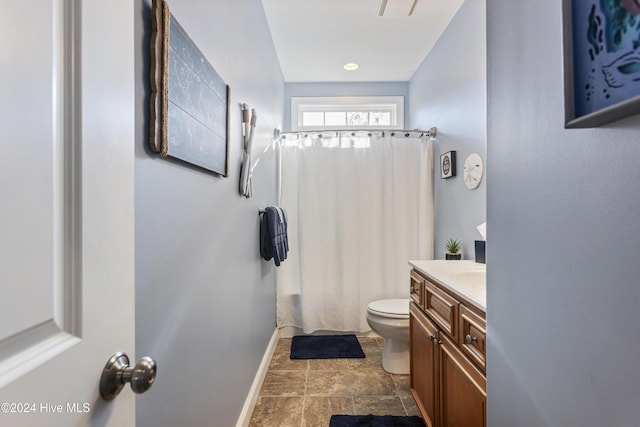 bathroom with curtained shower, vanity, and toilet