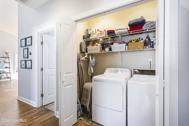 washroom with washing machine and dryer and wood-type flooring