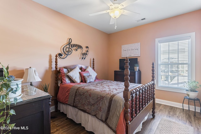 bedroom with dark hardwood / wood-style floors and ceiling fan