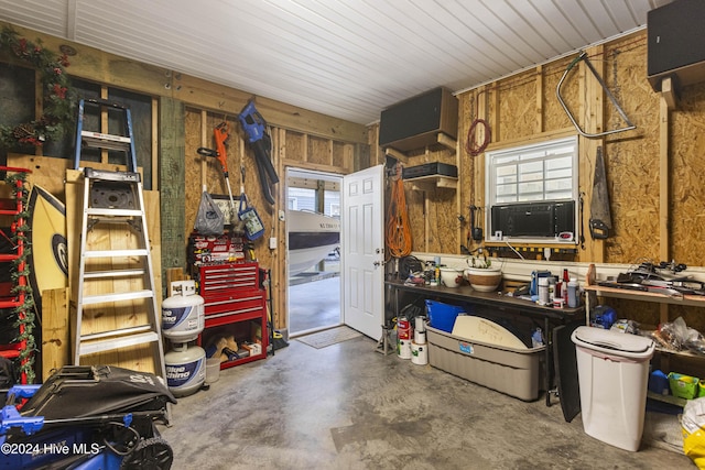 misc room with a workshop area and concrete flooring