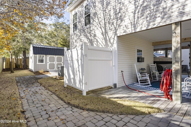 view of side of home with a storage shed