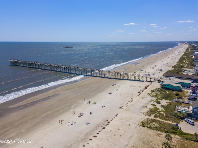 drone / aerial view with a water view and a beach view