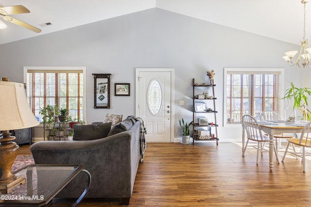 living room featuring ceiling fan with notable chandelier, dark hardwood / wood-style floors, high vaulted ceiling, and plenty of natural light