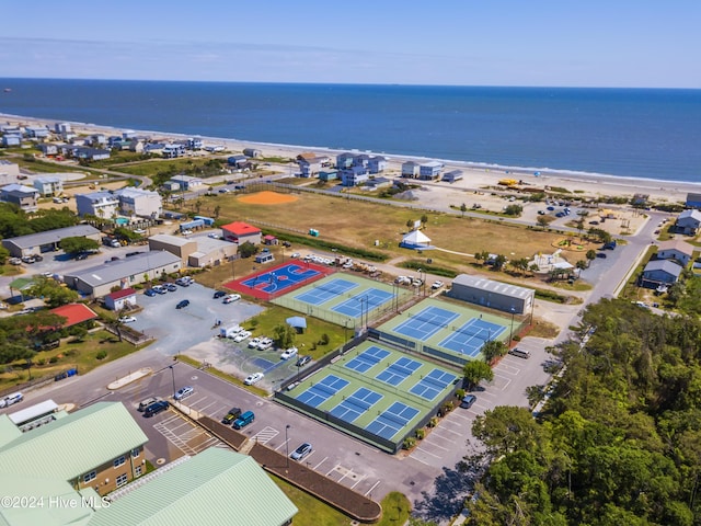 drone / aerial view featuring a water view and a view of the beach