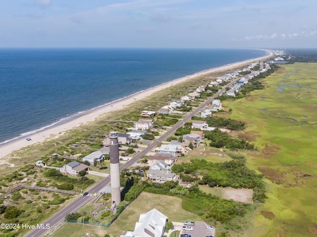 drone / aerial view with a water view and a beach view