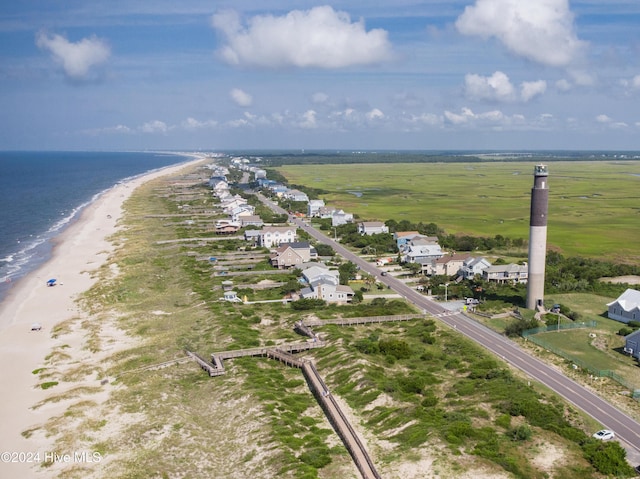 drone / aerial view with a rural view, a water view, and a beach view