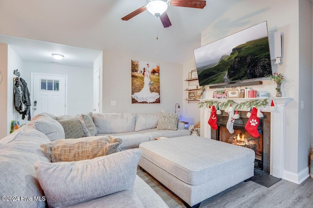 living room featuring hardwood / wood-style floors and ceiling fan