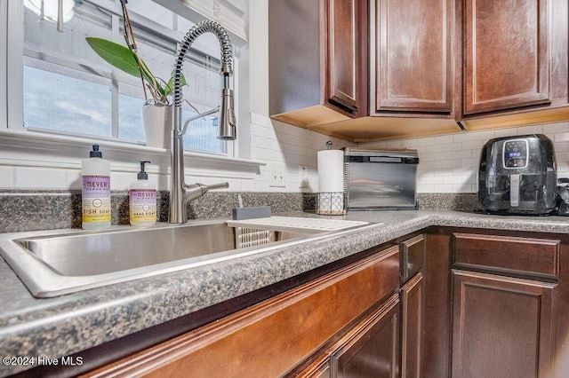 kitchen with decorative backsplash and sink