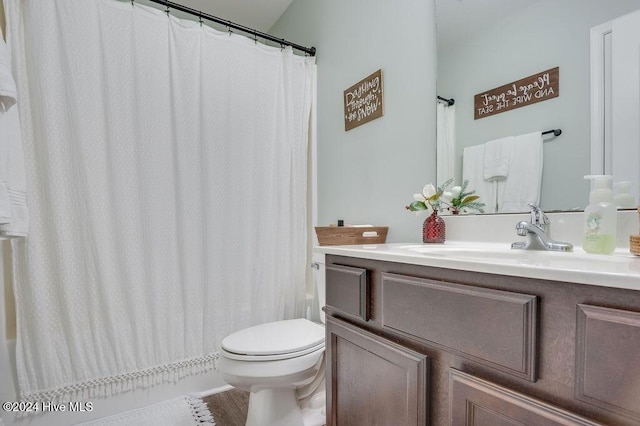 bathroom with hardwood / wood-style floors, vanity, and toilet