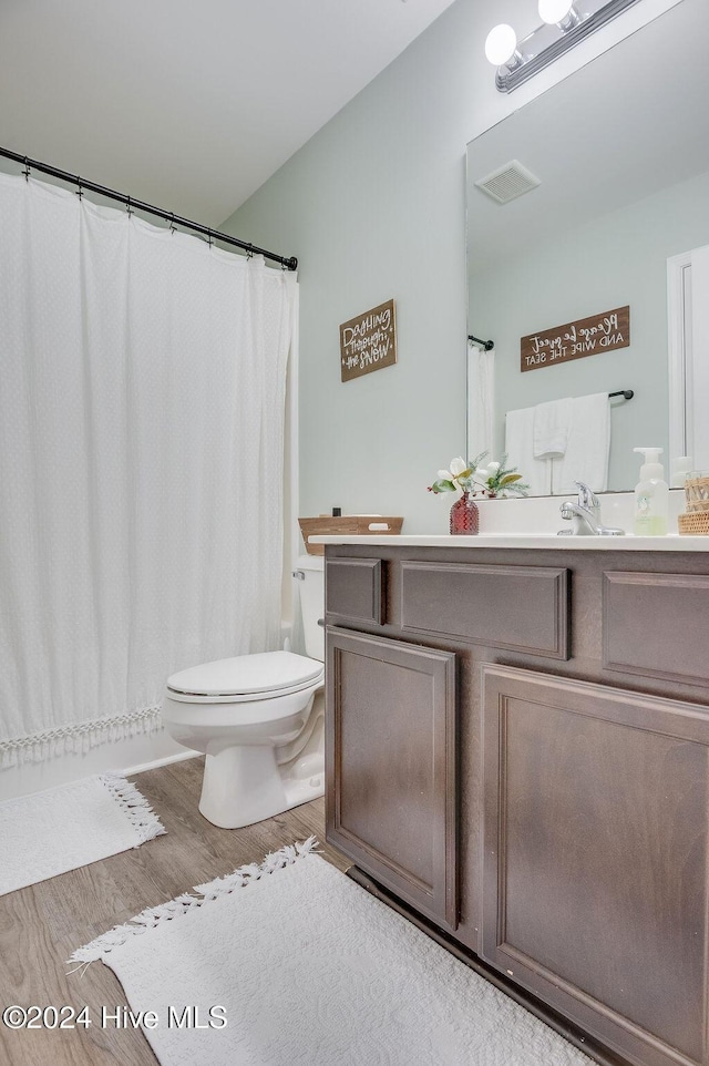 bathroom featuring hardwood / wood-style floors, vanity, and toilet