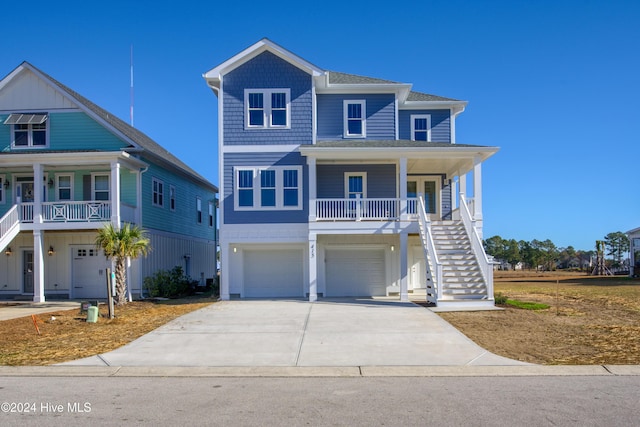 view of front of property with a porch and a garage