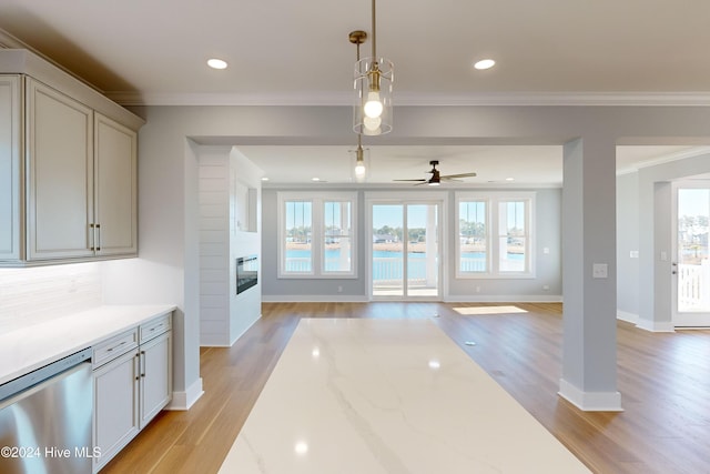 interior space with stainless steel dishwasher, light hardwood / wood-style floors, and a wealth of natural light