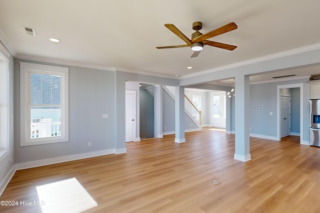 unfurnished living room with light hardwood / wood-style flooring, ceiling fan with notable chandelier, and ornamental molding