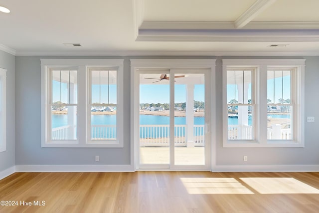 doorway to outside featuring a water view, plenty of natural light, and light hardwood / wood-style floors