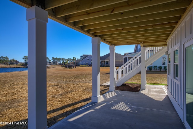 view of patio with a water view