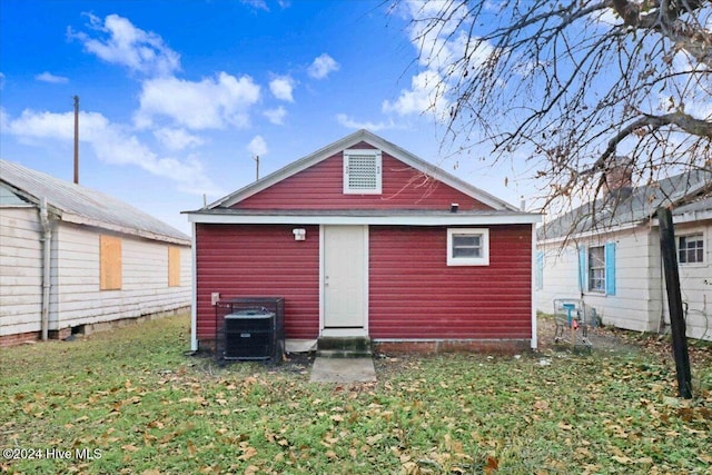 rear view of house with a yard and central air condition unit