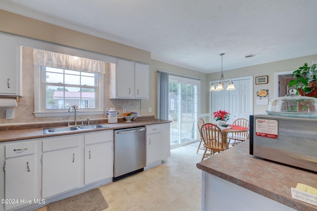 kitchen featuring appliances with stainless steel finishes, hanging light fixtures, a healthy amount of sunlight, and sink