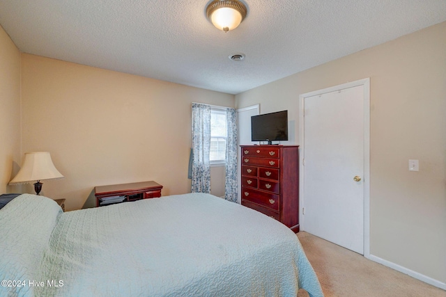 carpeted bedroom with a textured ceiling